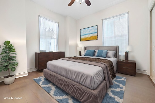 bedroom with ceiling fan and wood-type flooring