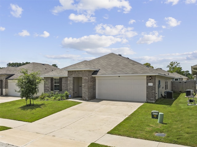 view of front facade with a front lawn, central AC unit, and a garage