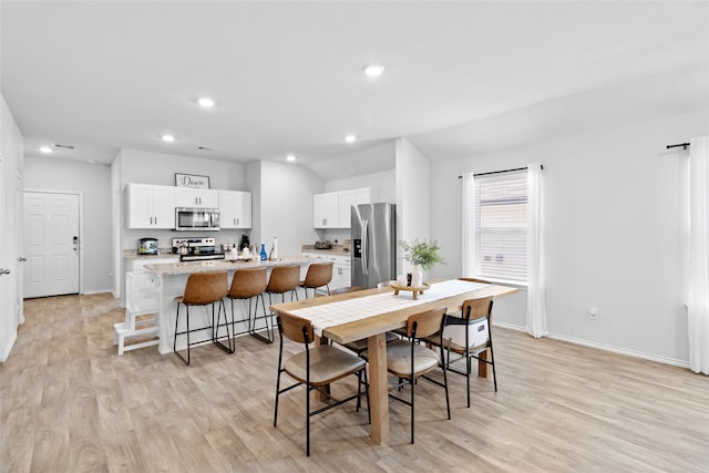 dining space with light hardwood / wood-style floors