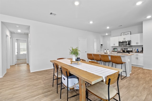 dining space featuring light hardwood / wood-style floors