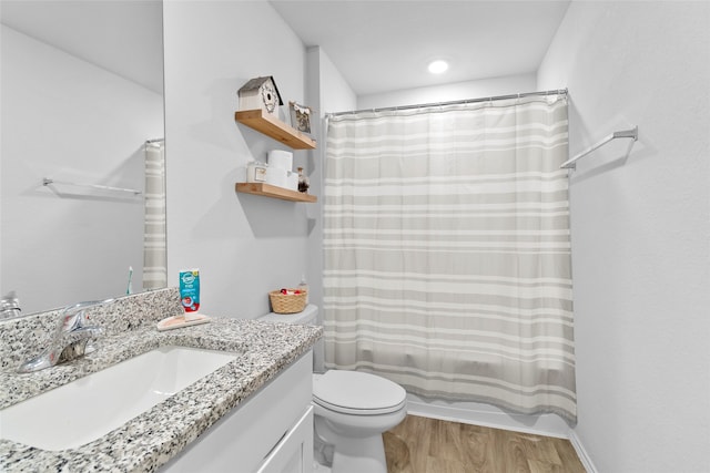 full bathroom with hardwood / wood-style floors, vanity, shower / bath combination with curtain, and toilet