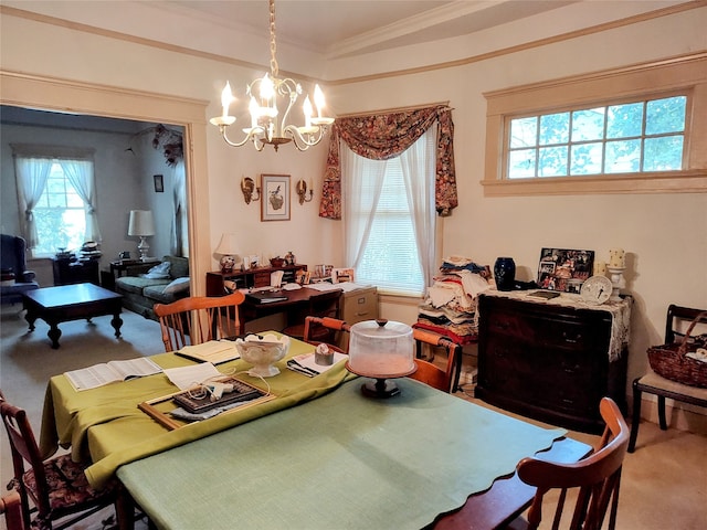 carpeted dining space featuring crown molding and an inviting chandelier