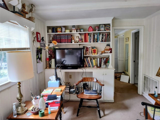 sitting room with carpet flooring, ornamental molding, and a wealth of natural light