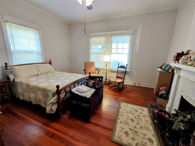 bedroom with dark hardwood / wood-style floors, multiple windows, ornamental molding, and ceiling fan