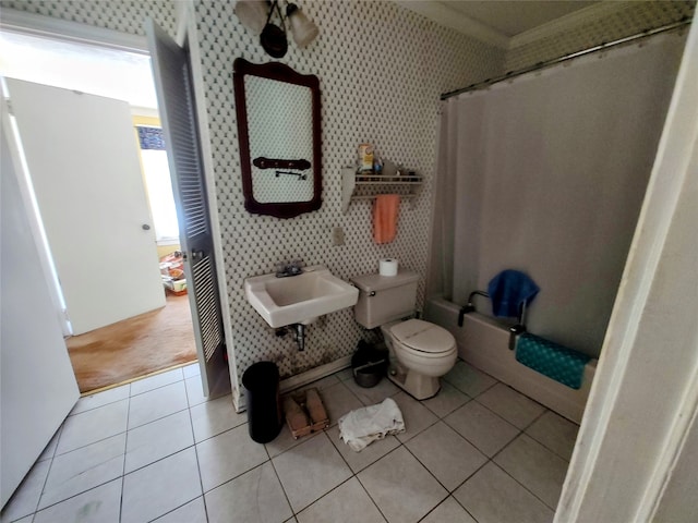 full bathroom with toilet, tile patterned floors, shower / tub combo with curtain, and sink