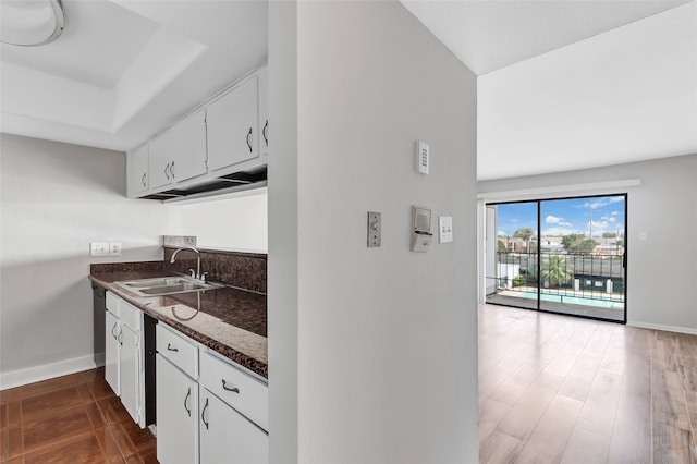 kitchen with white cabinets, dark wood-type flooring, and sink