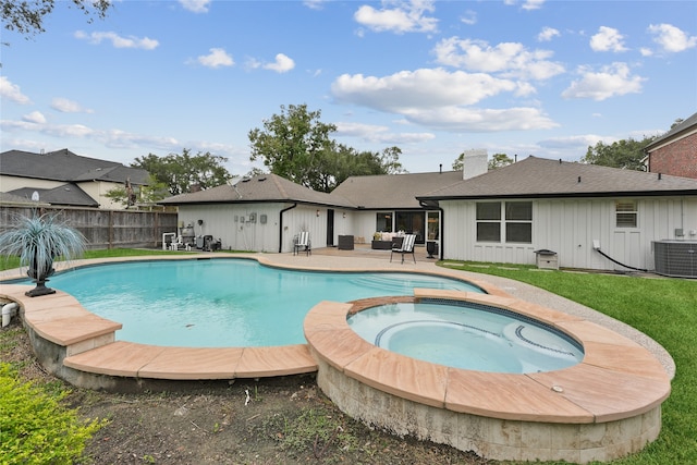 view of pool with an in ground hot tub, cooling unit, and a patio