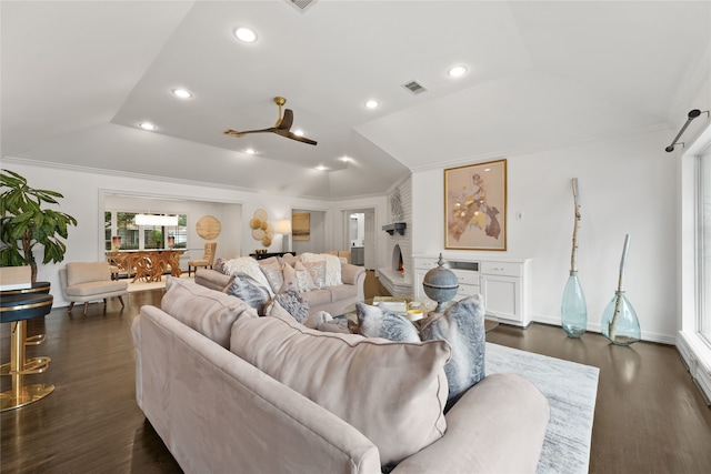 living room featuring ornamental molding, a raised ceiling, and dark wood-type flooring