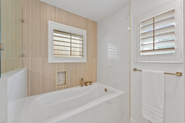 bathroom featuring a tub to relax in