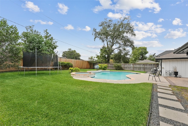 view of swimming pool featuring a patio area, a trampoline, and a yard