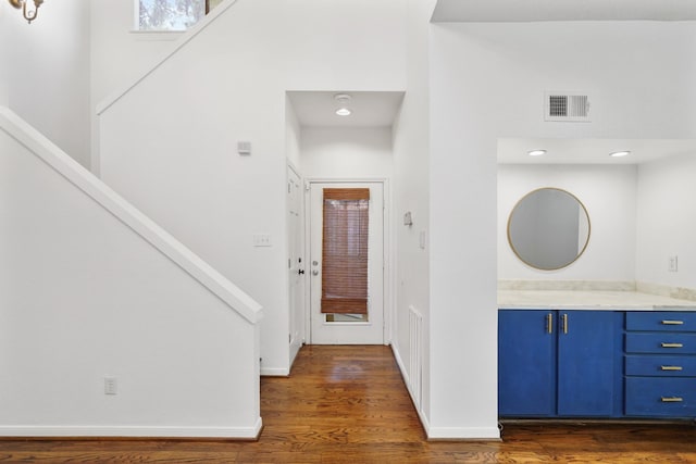 2555 Bering Dr Unit 1, Houston, TX 77057 - foyer entrance with stairway, dark wood-style floors, baseboards, visible vents, and a towering ceiling