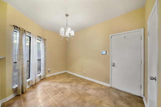 spare room with an inviting chandelier