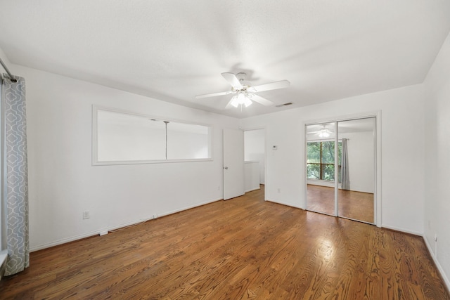 2555 Bering Dr Unit 1, Houston, TX 77057 - unfurnished bedroom featuring visible vents, baseboards, ceiling fan, and wood finished floors