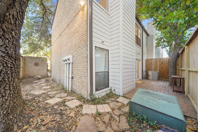 view of home's exterior featuring cooling unit and a wooden deck