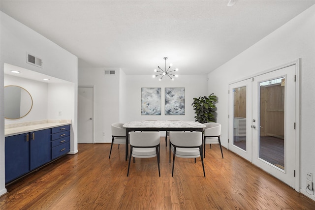 2555 Bering Dr Unit 1, Houston, TX 77057 - dining room featuring french doors, wood finished floors, a notable chandelier, and visible vents