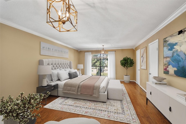 2555 Bering Dr Unit 1, Houston, TX 77057 - bedroom with ornamental molding, baseboards, a chandelier, a textured ceiling, and wood finished floors