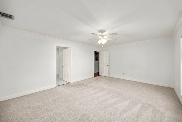 carpeted empty room with ceiling fan and ornamental molding