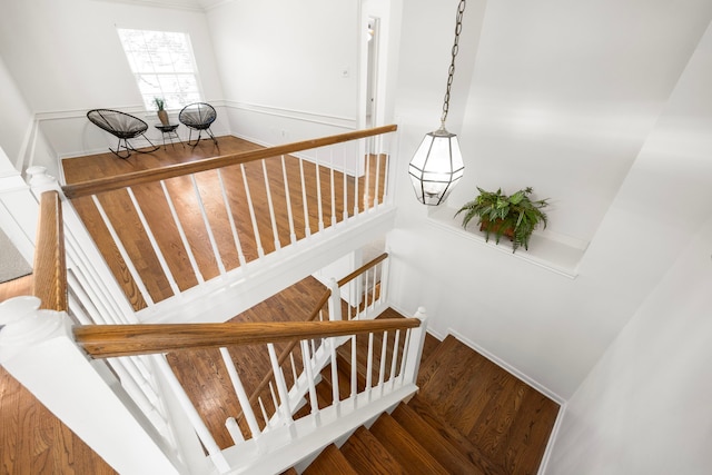 stairs featuring hardwood / wood-style floors