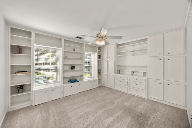 unfurnished living room featuring ceiling fan and light colored carpet