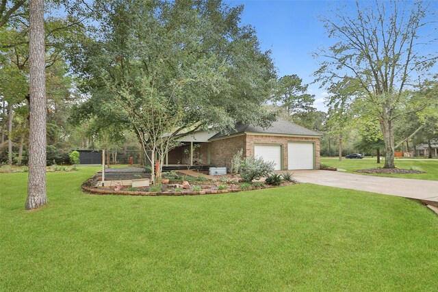 view of front of property featuring brick siding, a vegetable garden, concrete driveway, a garage, and a front lawn