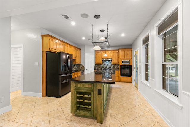 kitchen with a kitchen island, visible vents, backsplash, black appliances, and dark countertops