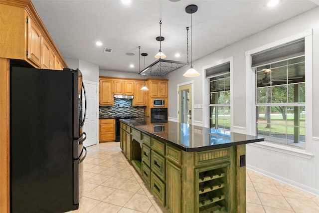 kitchen with hanging light fixtures, a kitchen island, backsplash, light tile patterned flooring, and black appliances