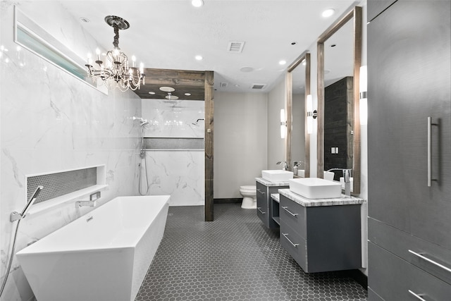 full bath featuring tile walls, visible vents, a freestanding bath, toilet, and vanity