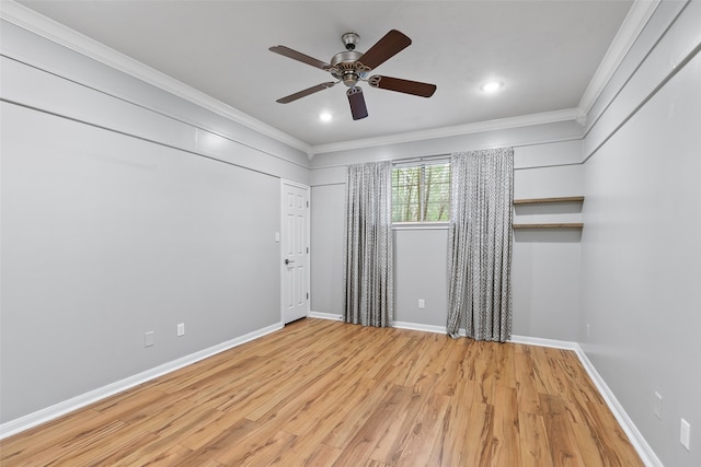 spare room featuring crown molding, recessed lighting, ceiling fan, wood finished floors, and baseboards