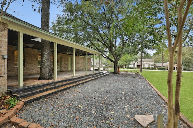 view of yard with a patio and ceiling fan