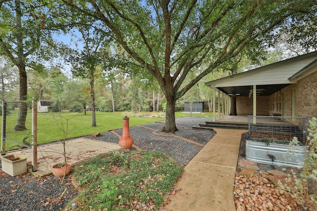 view of yard with a ceiling fan and a patio