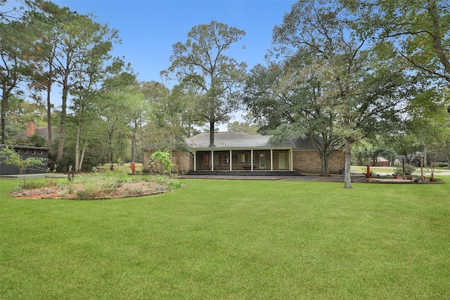 view of yard featuring a sunroom