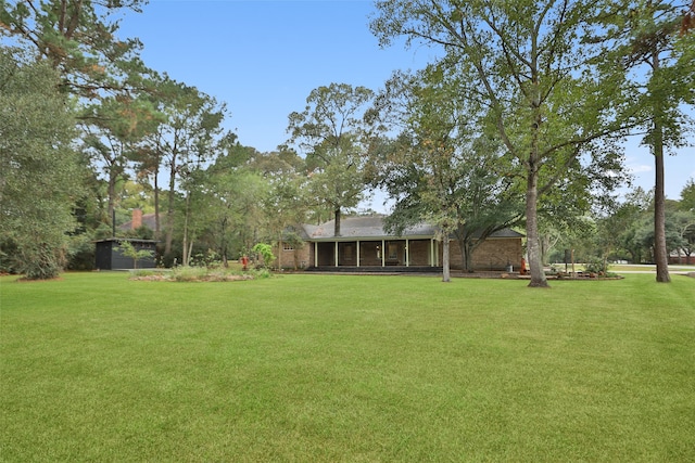 view of yard featuring a sunroom