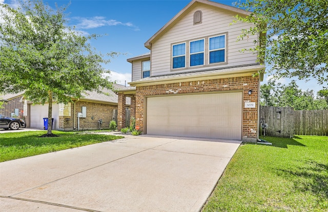 view of front of home with a front yard and a garage