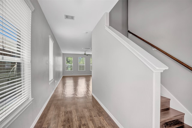 corridor with hardwood / wood-style floors