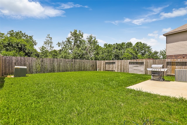 view of yard featuring central AC and a patio