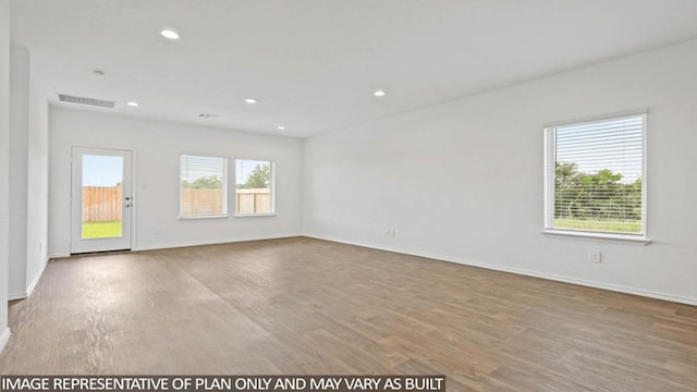 empty room with hardwood / wood-style flooring