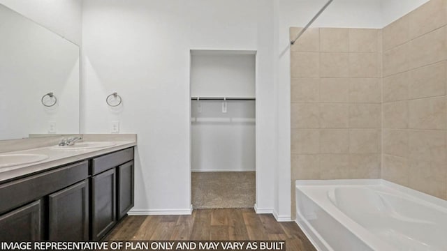 23520 Nectar Crest Hts, Splendora, TX 77372 - full bathroom with a bathtub, wood finished floors, double vanity, a spacious closet, and a shower