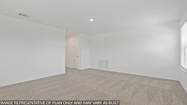 empty room with light colored carpet