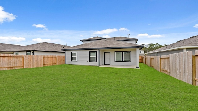 back of house featuring a yard