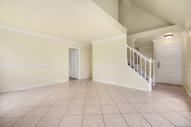 interior space with light tile patterned floors, lofted ceiling, and ornamental molding