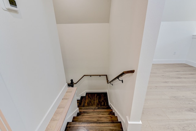 stairway featuring wood-type flooring