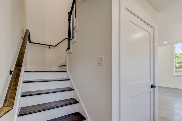 staircase with concrete flooring