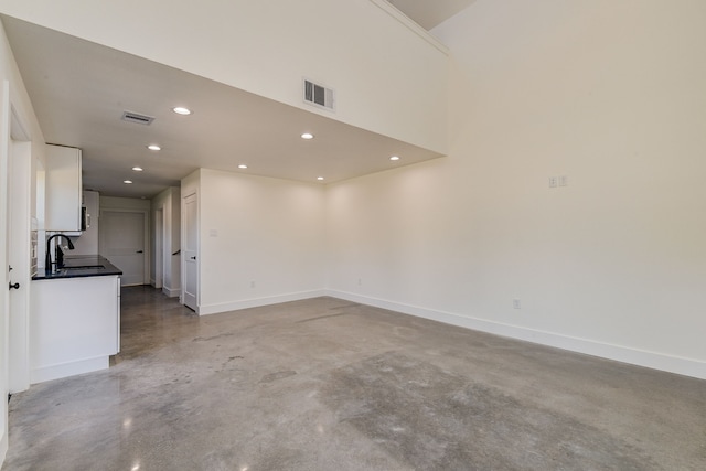 unfurnished room with sink and concrete flooring