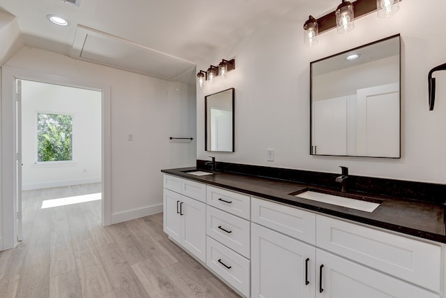 bathroom with hardwood / wood-style floors and vanity