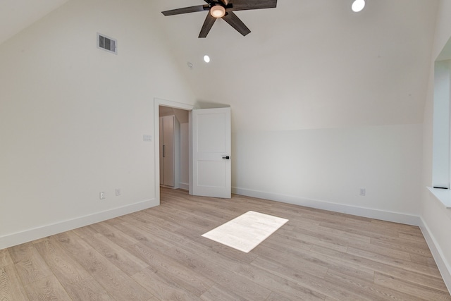 empty room featuring ceiling fan, light hardwood / wood-style floors, and high vaulted ceiling