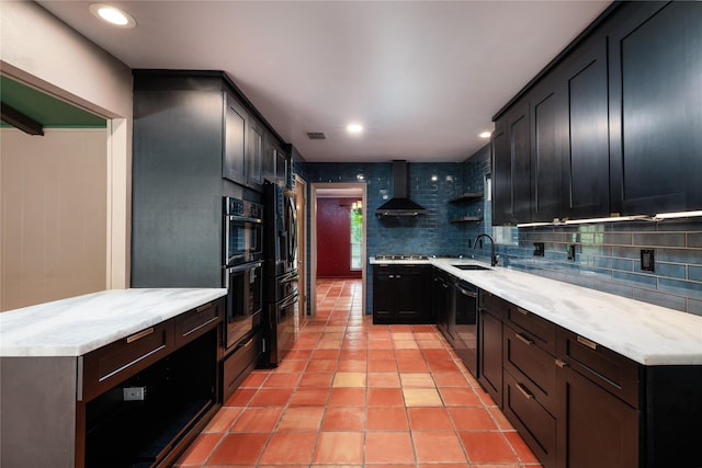 kitchen featuring decorative backsplash, stainless steel appliances, sink, wall chimney range hood, and light tile patterned flooring