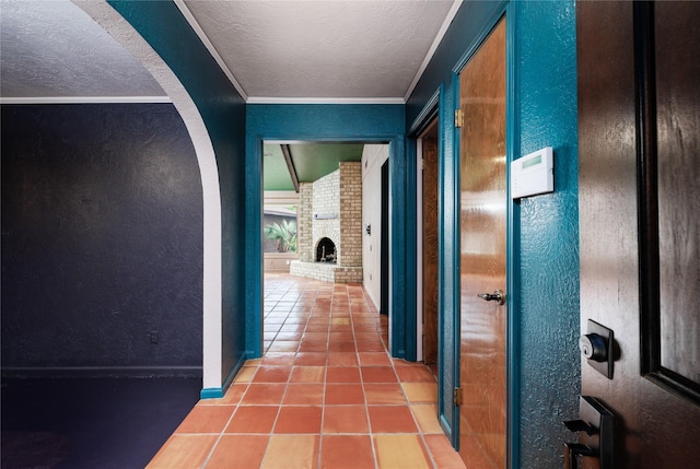 hallway featuring tile patterned flooring and ornamental molding