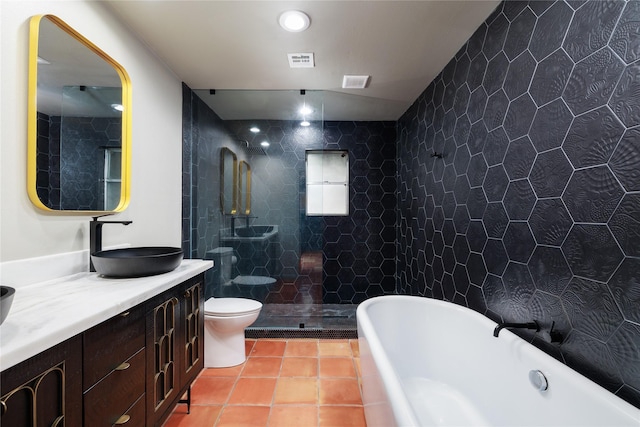 full bathroom featuring tile patterned flooring, separate shower and tub, toilet, vanity, and tile walls