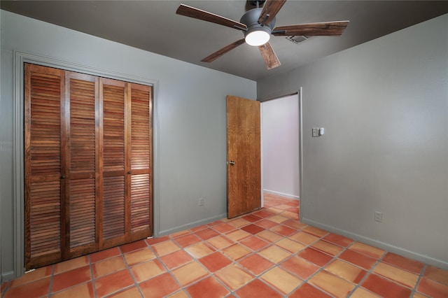 unfurnished bedroom featuring ceiling fan, a closet, and light tile patterned flooring