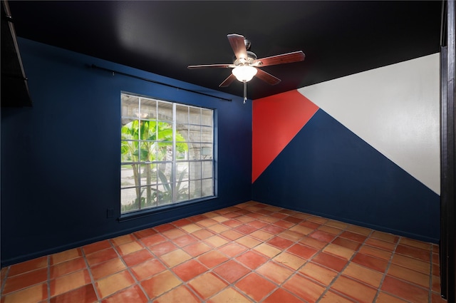 tiled spare room with ceiling fan